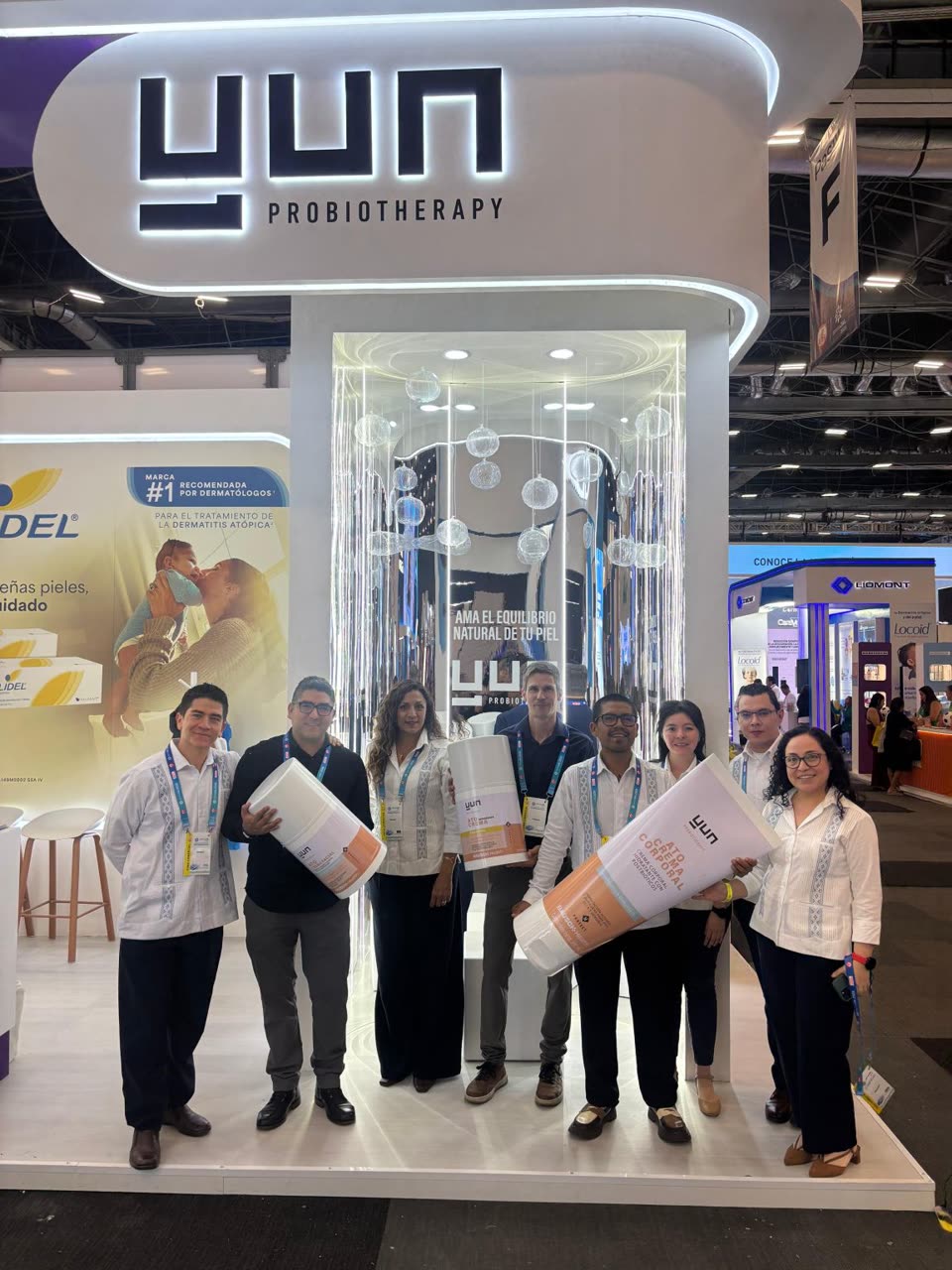 The launch team at the YUN Probiotherapy stand at dermaJAL 2026, holding oversized ATO product displays